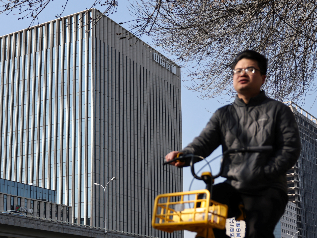 A man rides a bicycle past a building housing the National Engineering Research Centre for Rare Earth in Beijing. File photo: Reuters
