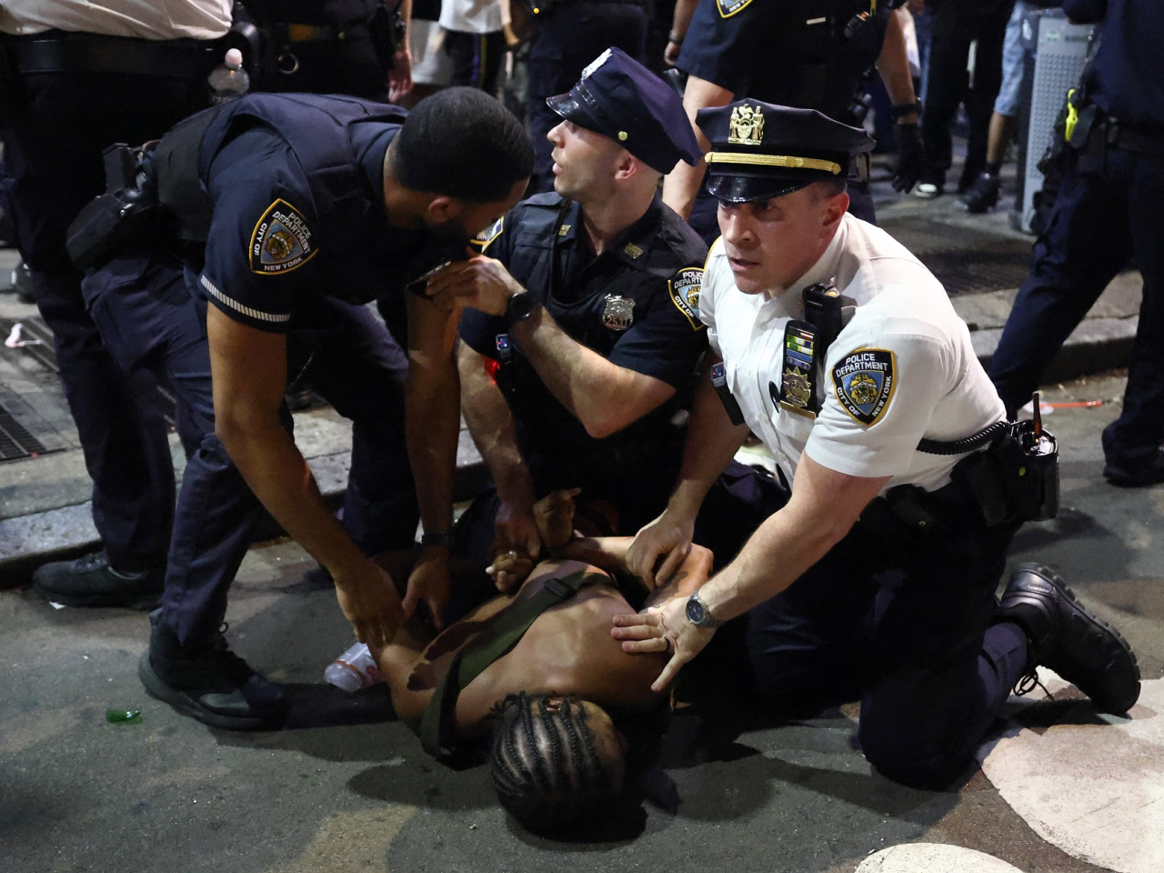 NYPD officers detain a man after clashes outside Madison Square Garden after the New York Knicks' victory over San Antonio in Game 4 of the NBA Finals. Photo: AFP