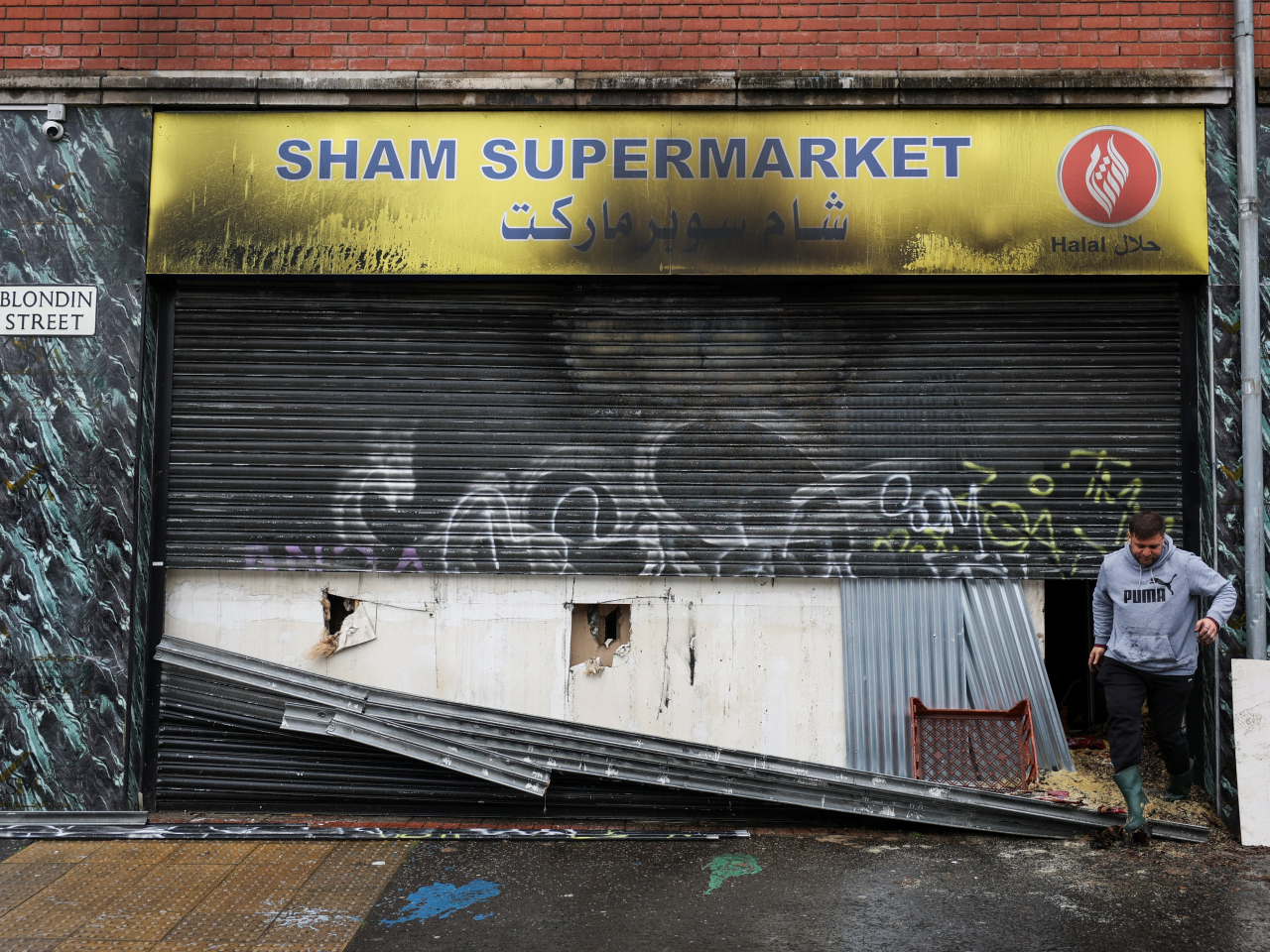 A supermarket run by a Belfast resident of Syrian origins is left in ruins following anti-immigrant protests. Photo: Reuters