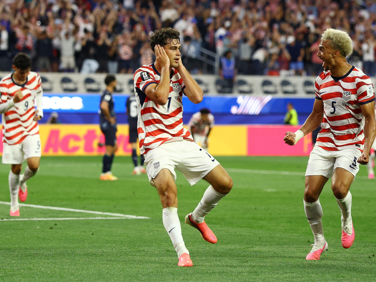 Giovanni Reyna, left, celebrates with Antonee Robinson after scoring the fourth goal for the US against Paraguay. Photo: Reuters