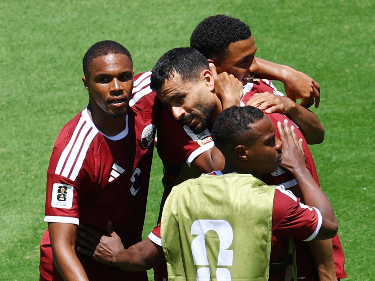 Qatar's Boualem Khoukhi celebrates scoring their first goal with teammates to earn his side a 1-1 draw with Switzerland. Photo: Reuters