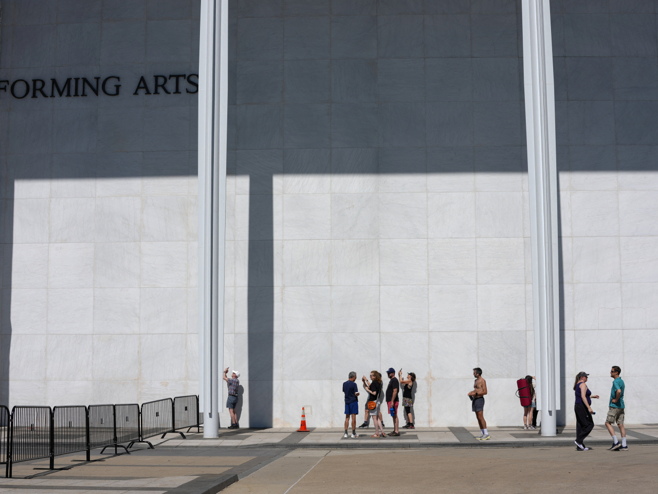 Members of the public take photos after the removal of Trump's name from the John F. Kennedy Memorial Center for the Performing Arts. Photo: Reuters