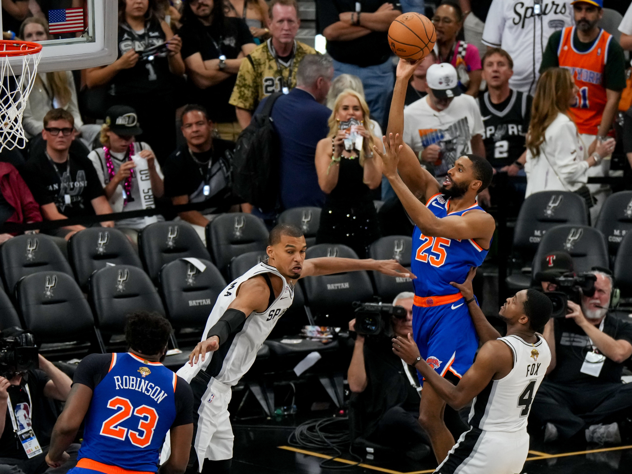 New York Knicks guard Mikal Bridges (25) shoots over San Antonio Spurs forward Victor Wembanyama in the second half during game five of the 2026 NBA Finals. Photo: Reuters