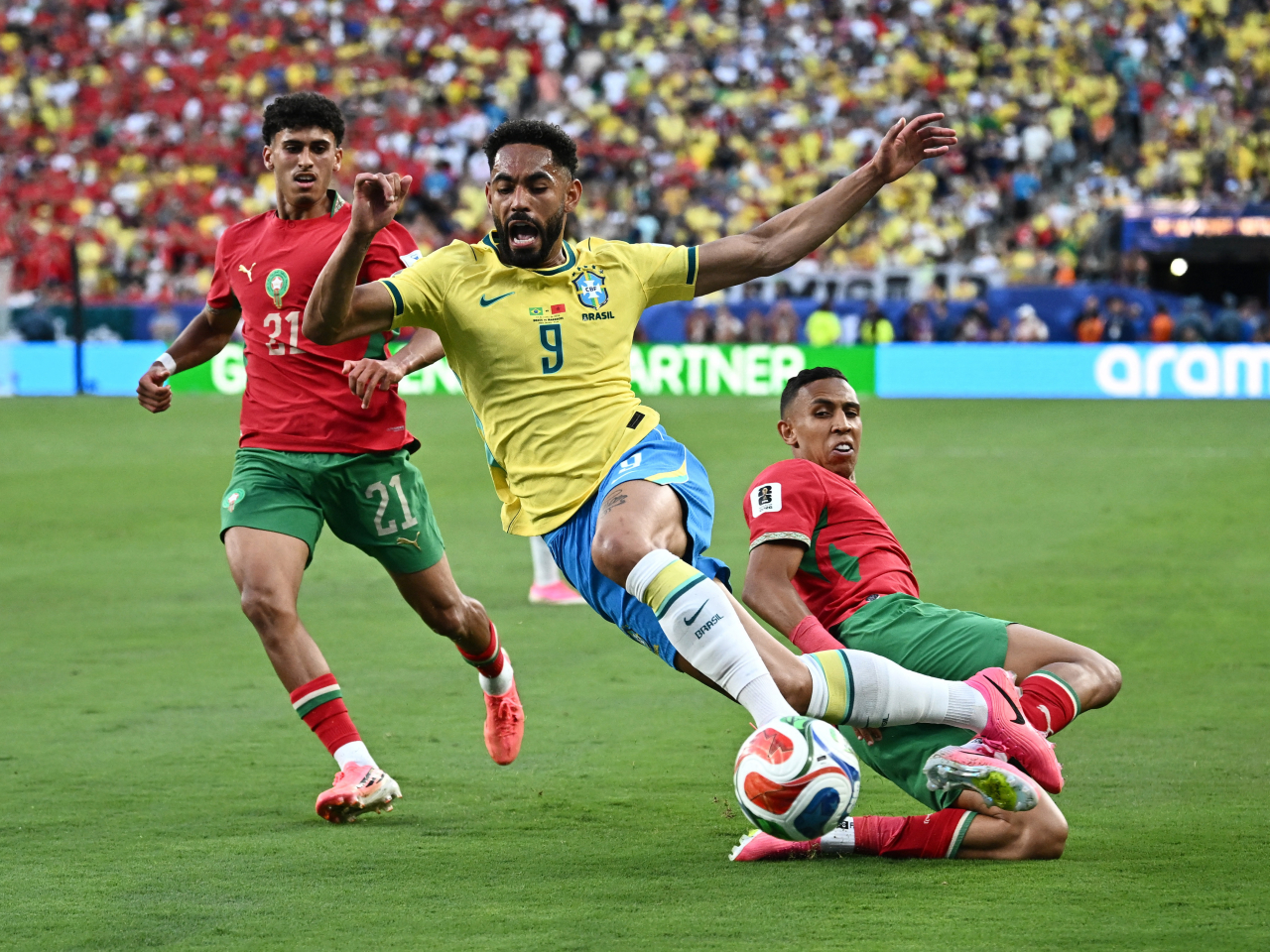 Brazil's Matheus Cunha in action with Morocco's Ayoub Amaimouni and Anass Salah Eddine. Photo: Reuters