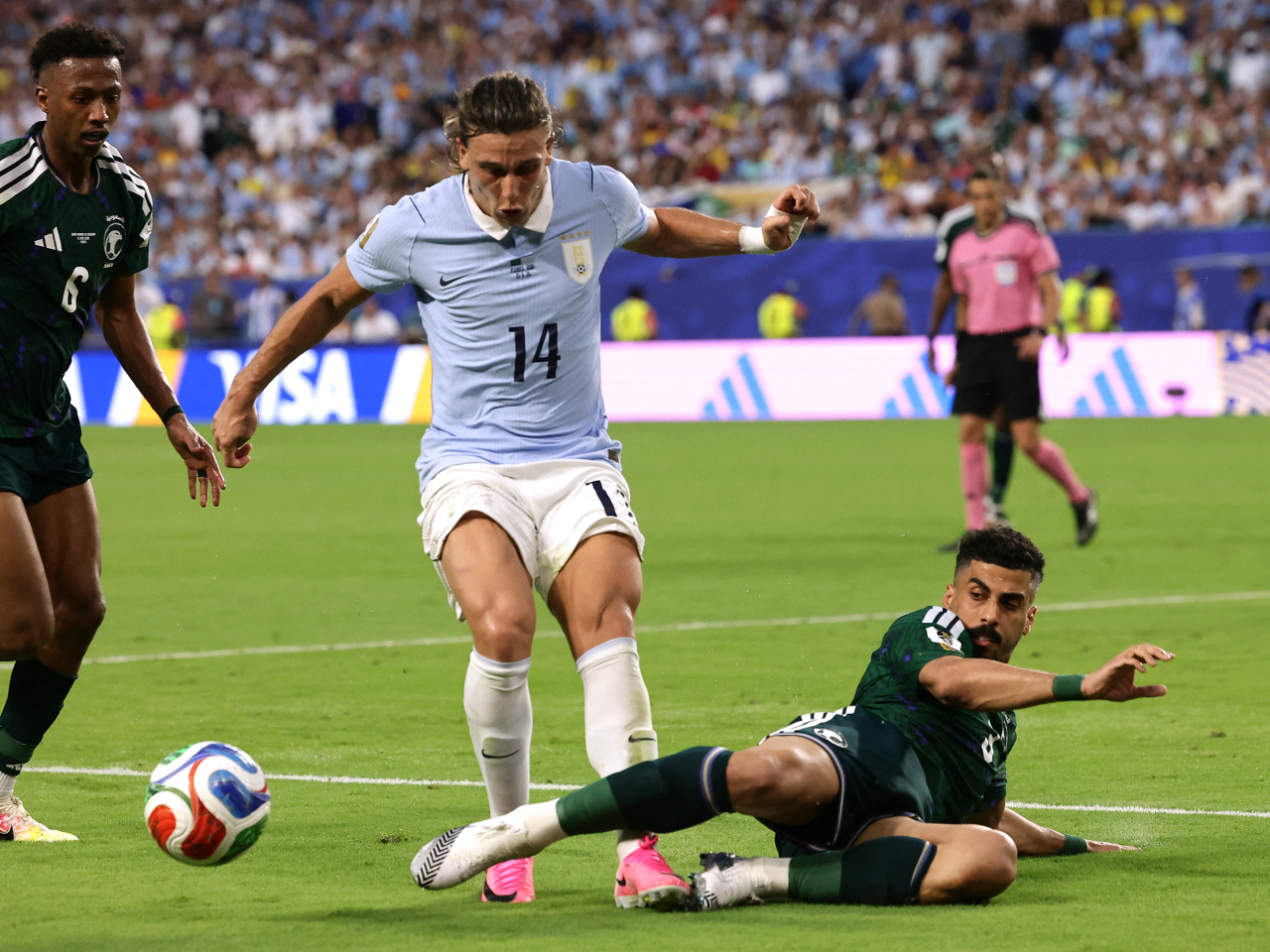 Uruguay's Agustin Canobbio in action with Saudi Arabia's Ali Lajami and Nasser Al-Dawsari. Photo: Reuters
