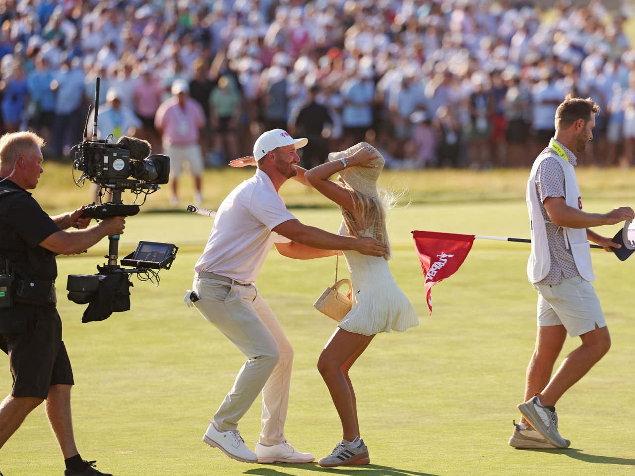 Wyndham Clark and his partner Emily Tanner celebrate after his win at Shinnecock Hills Golf Club. Photo: Bill Streicher-Imagn Images via Reuters