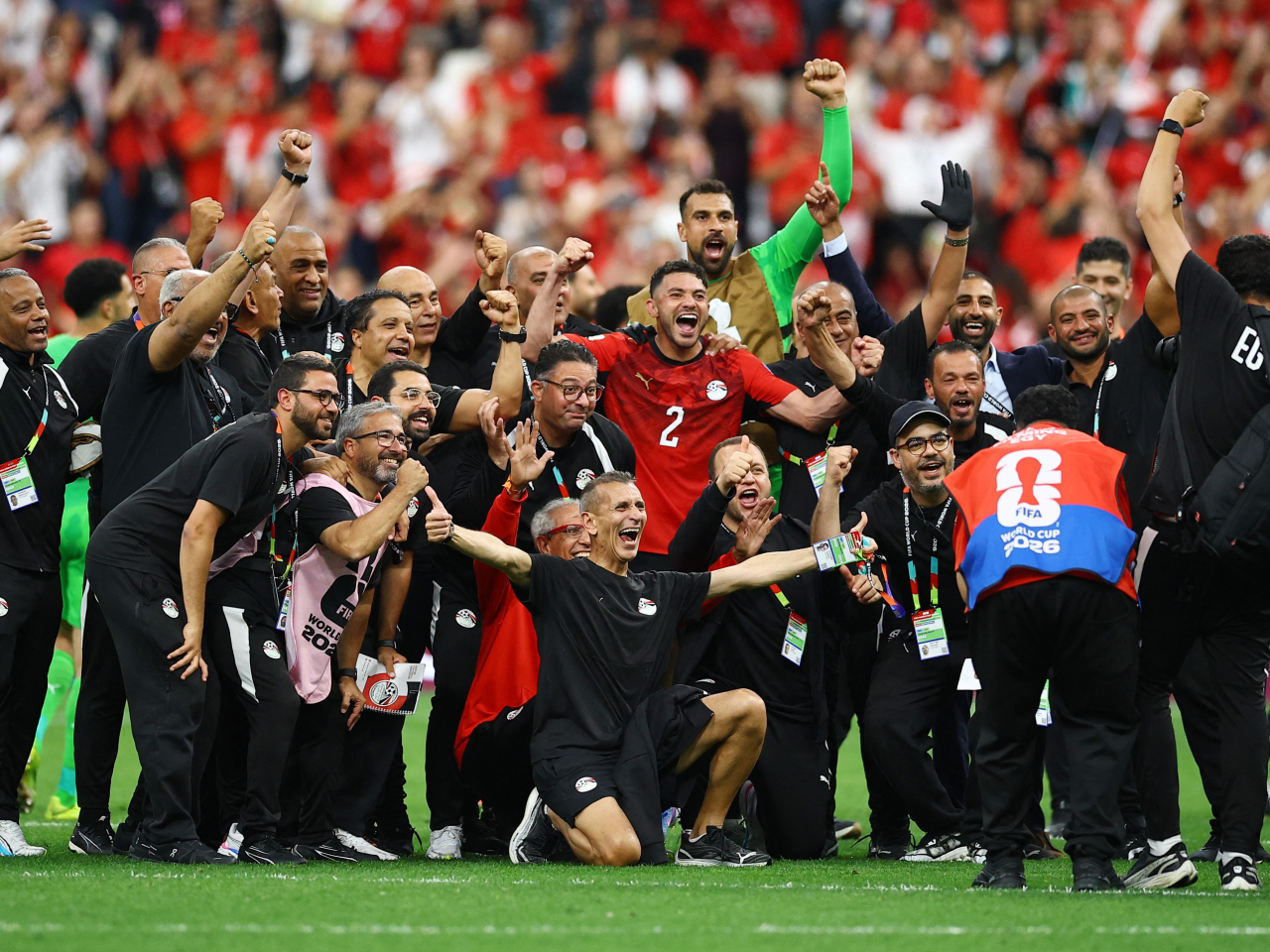 Egypt staff and players celebrate after the match which saw the team secure their first ever World Cup win and take a big step towards the knockout round. Photo: Reuters