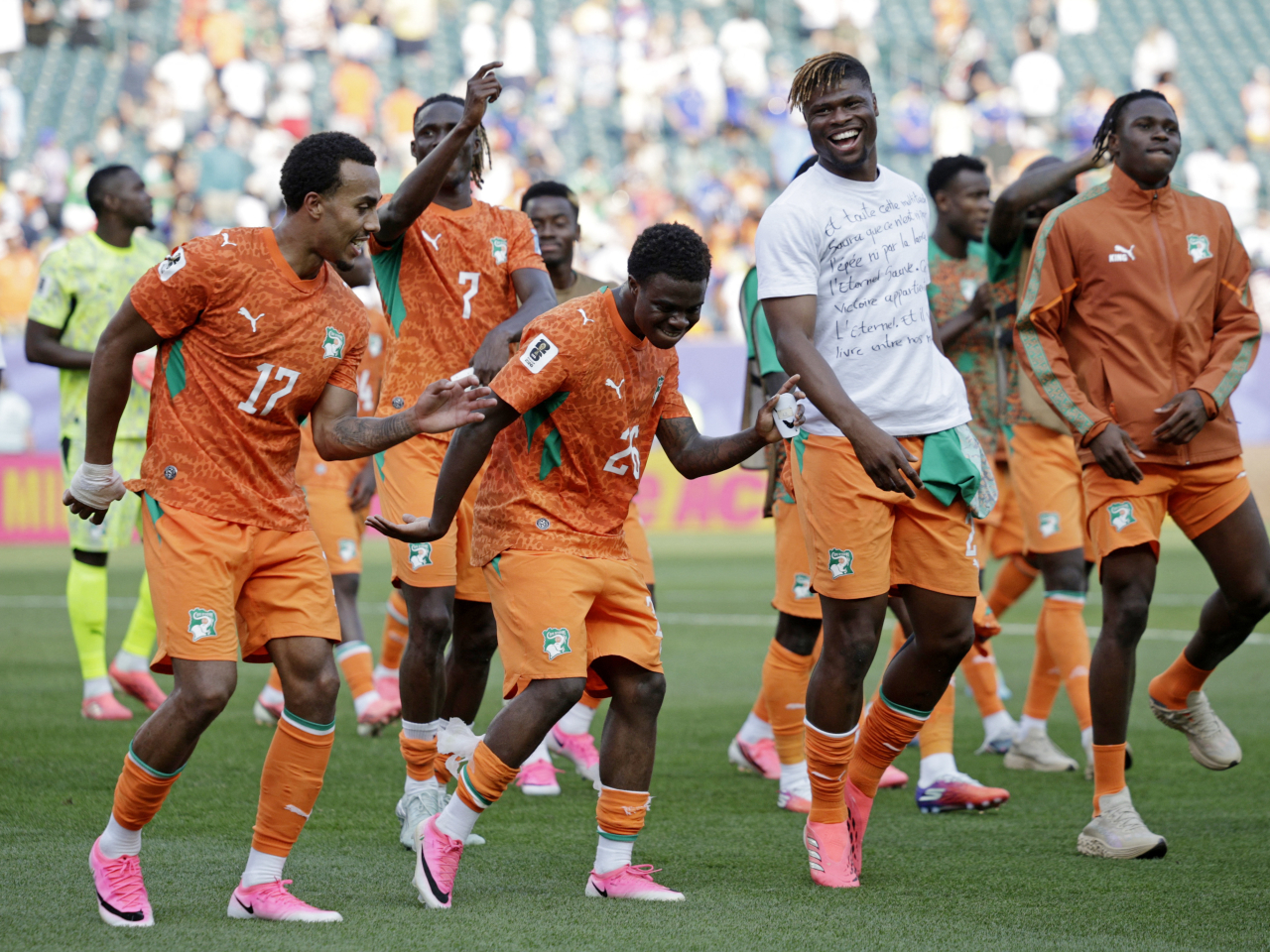 Ivory Coast players celebrate after earning a first-ever knockout stage appearance. Photo: Reuters