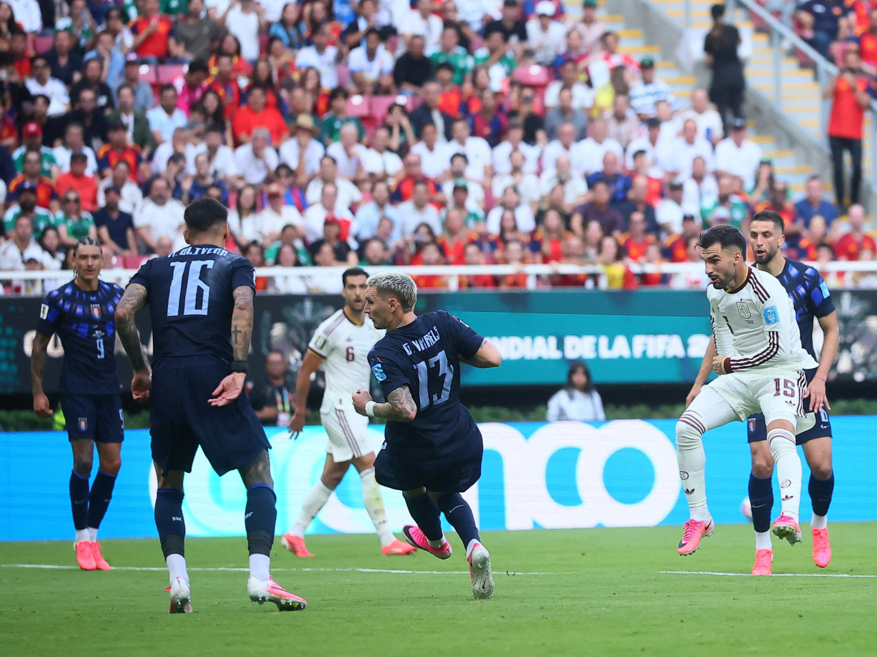 Alex Baena threads the ball through a phalanx of Uruguayan defenders for Spain's winning goal. Photo: Reuters