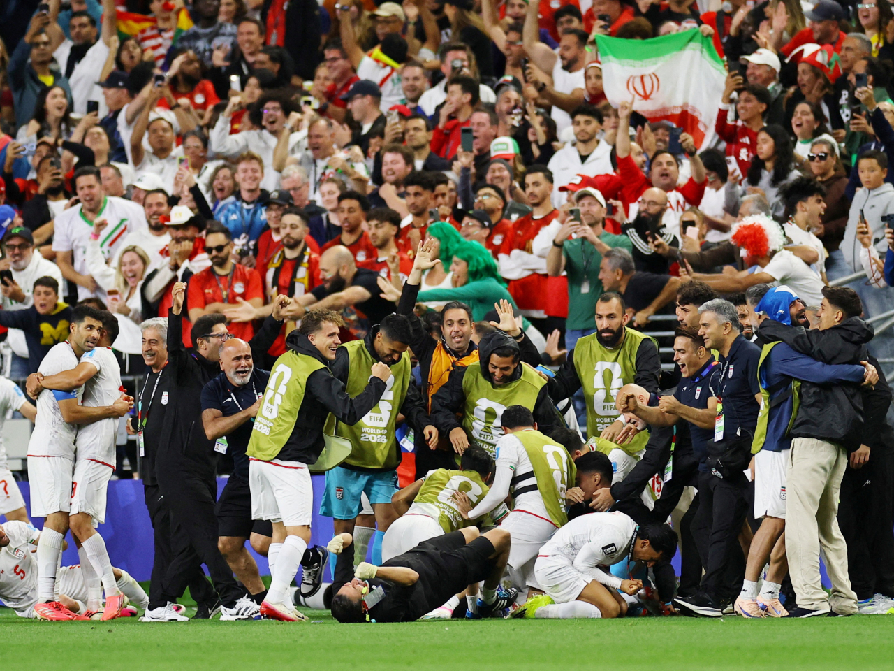 Iran players and staff celebrate a stoppage-time goal that is later disallowed following a VAR review. Photo: Reuters