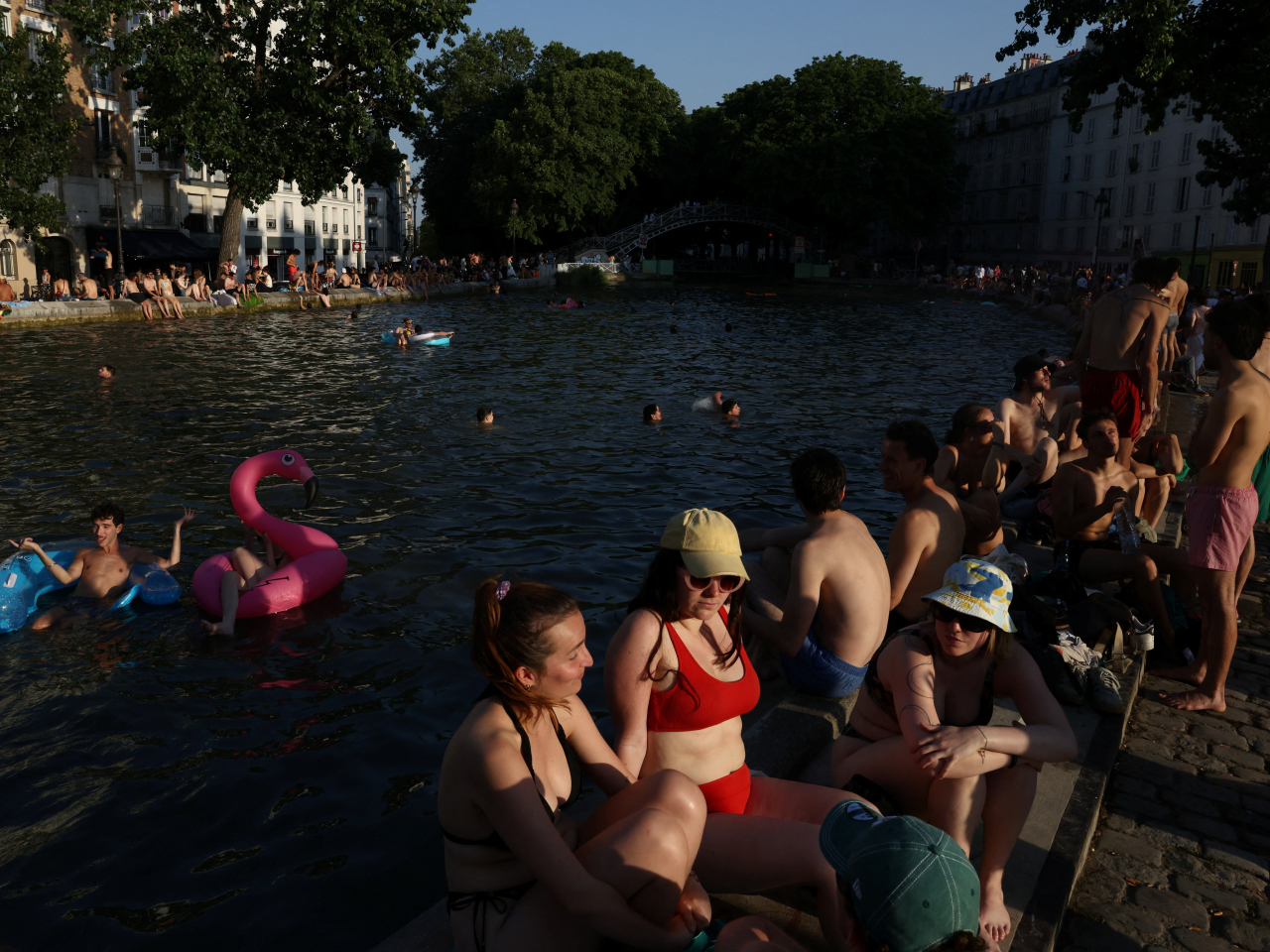 People take to the waters of Canal Saint-Martin in Paris amid the heatwave in Paris. Photo: Reuters