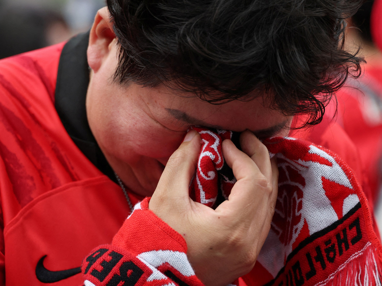 Fans in Seoul are dejected after South Korea lose to South Africa in their final group match. File photo: Reuters