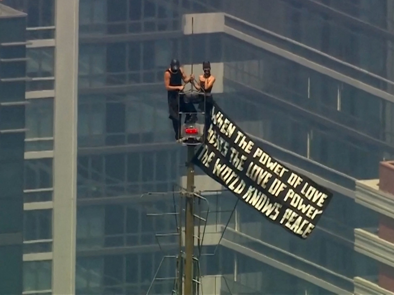 Angela Nikolau and Vanya Beerkus make a timely statement on top of Empire State Building's steeple in New York. Photo: Reuters