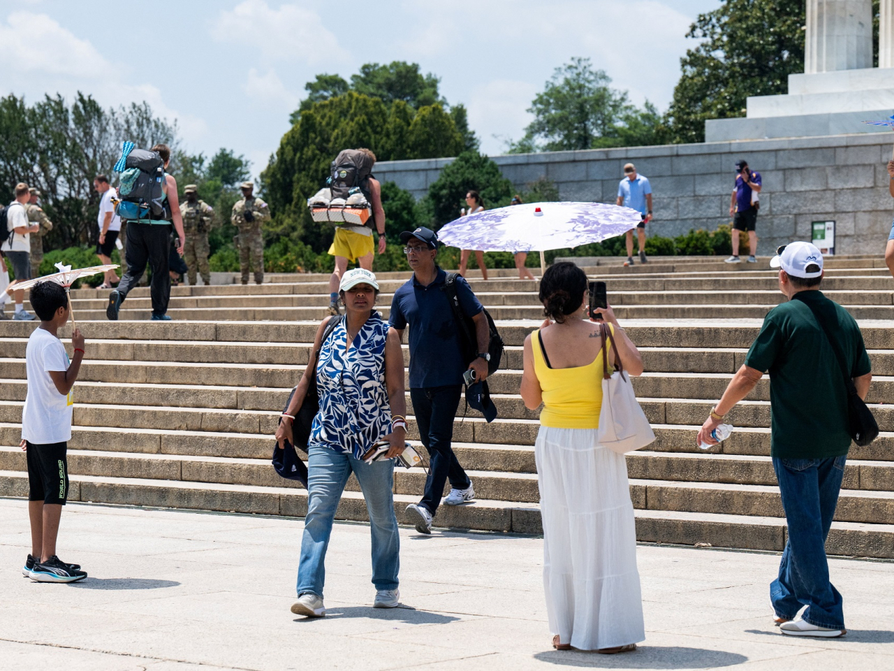 Visitors at the Lincoln Memorial use umbrellas to shield from the sun amid a heatwave in Washington, DC. Photo: Reuters