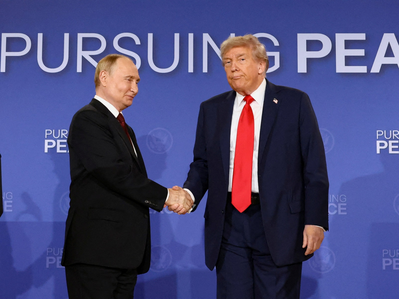 US President Donald Trump and Russian President Vladimir Putin shake hands after Ukraine peace talks in Alaska in 2025. File photo: Reuters