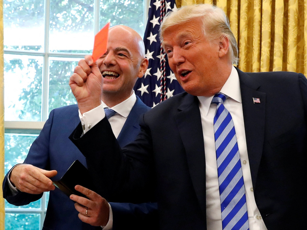 US President Donald Trump holds up a red card as he meets with Fifa President Gianni Infantino in the Oval Office. Photo: Reuters