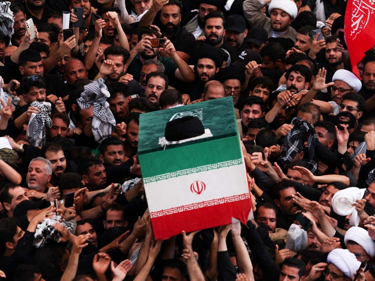 People push and shove in a desperate attempt to touch Khamenei's coffin. Photo: Reuters