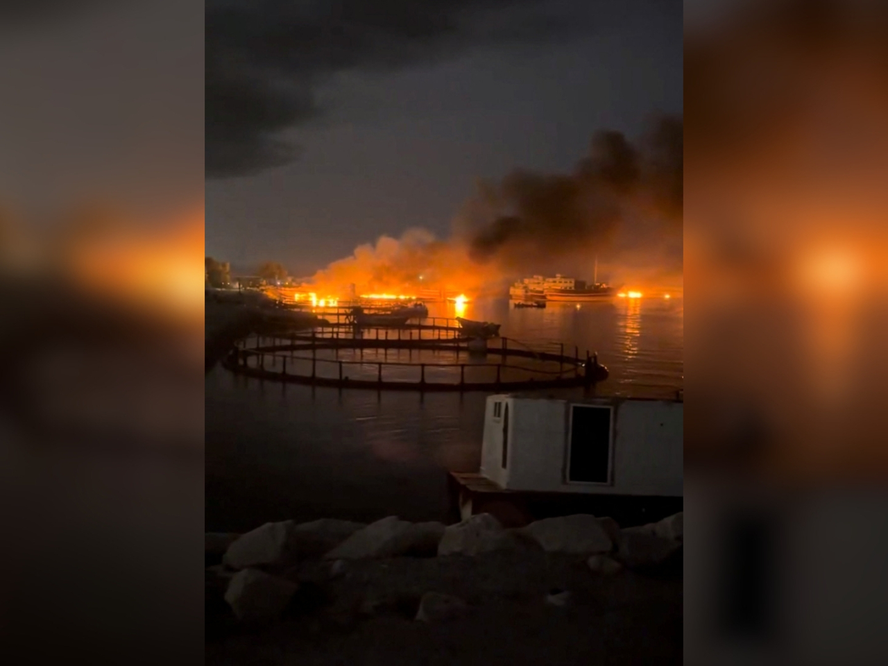 A screengrab from social media shows smoke rising from a port in Iran near the Strait of Hormuz following a US strike. Photo: Reuters