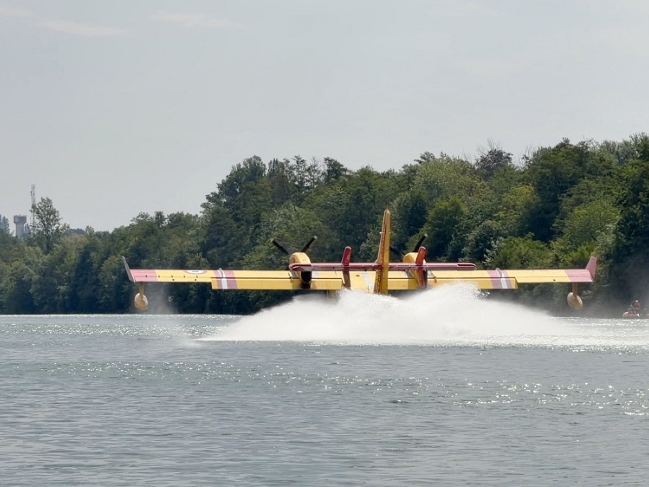 Canadair planes have joined the battle, scooping up water from the River Seine to douse the flames. Photo: Reuters