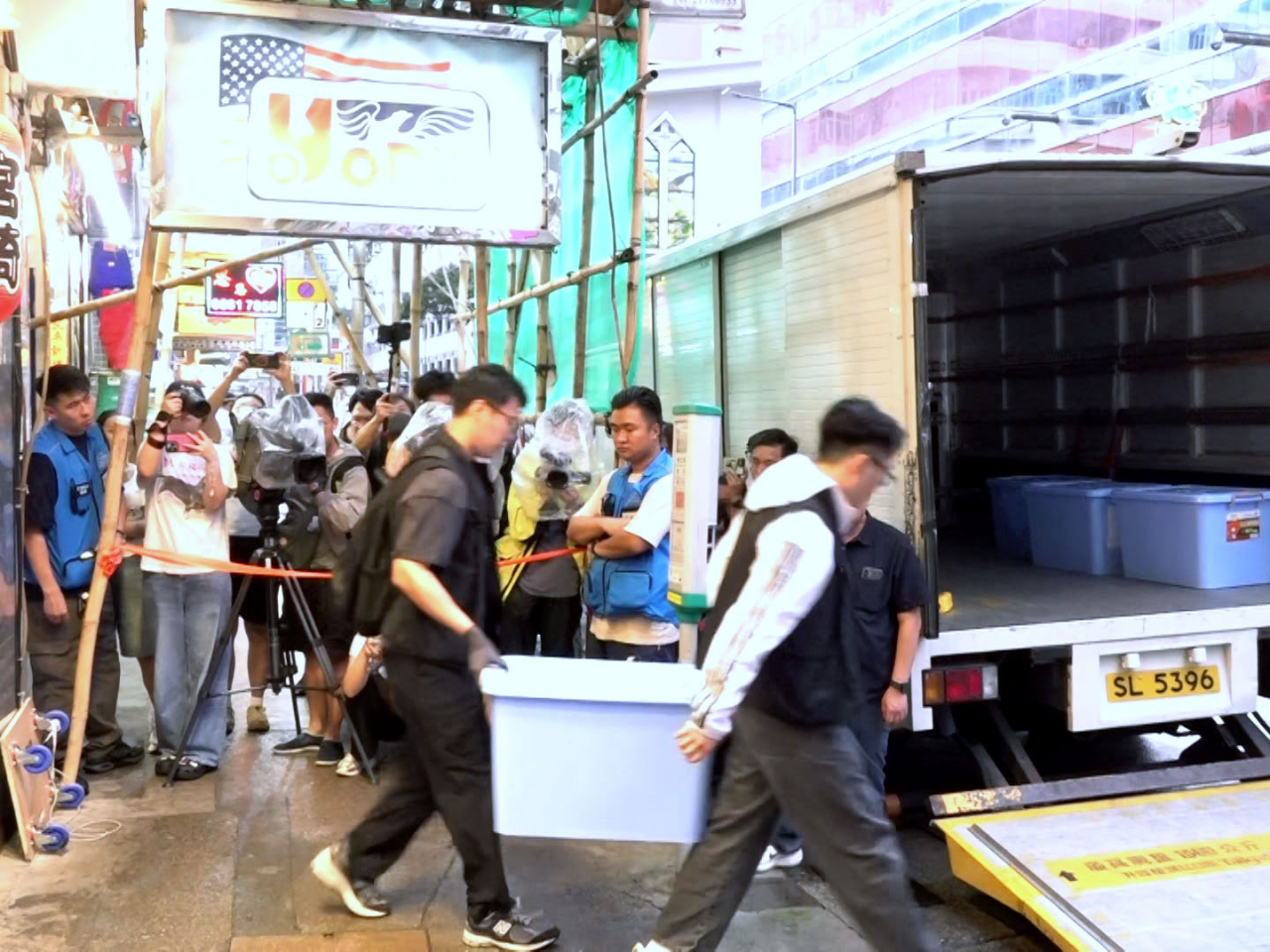 Officers took away multiple boxes of evidence following the operation. Photo: RTHK