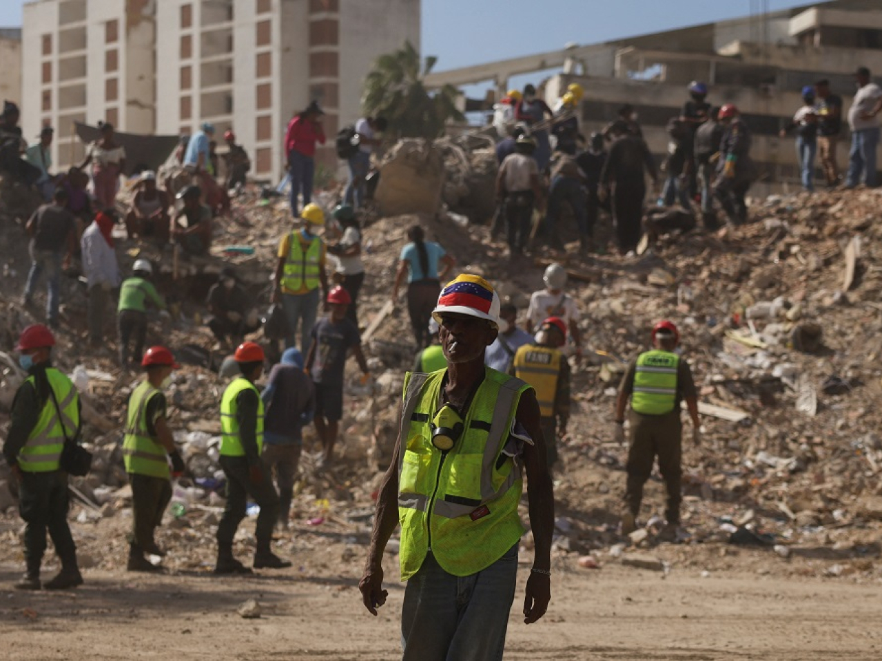 Rescue workers and relatives continue the search for the bodies of those still missing. Photo: Reuters