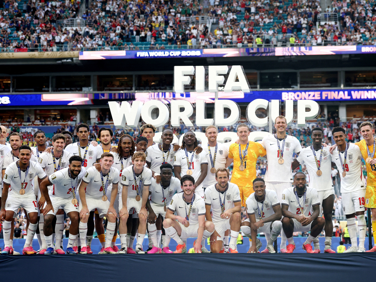 England players pose on the podium during the medal ceremony after winning the Bronze Final against France. Photo: Reuters