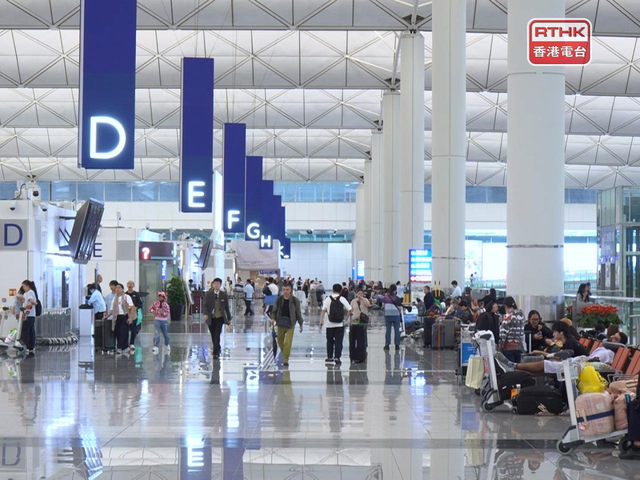 在機場離境大堂，坐滿不少候機的旅客。（鍾家銘攝）