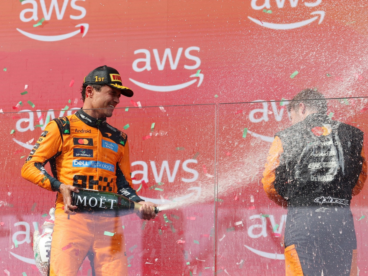 McLaren's Lando Norris celebrates with champagne on the podium after winning the Hungarian Grand Prix. Photo: Reuters