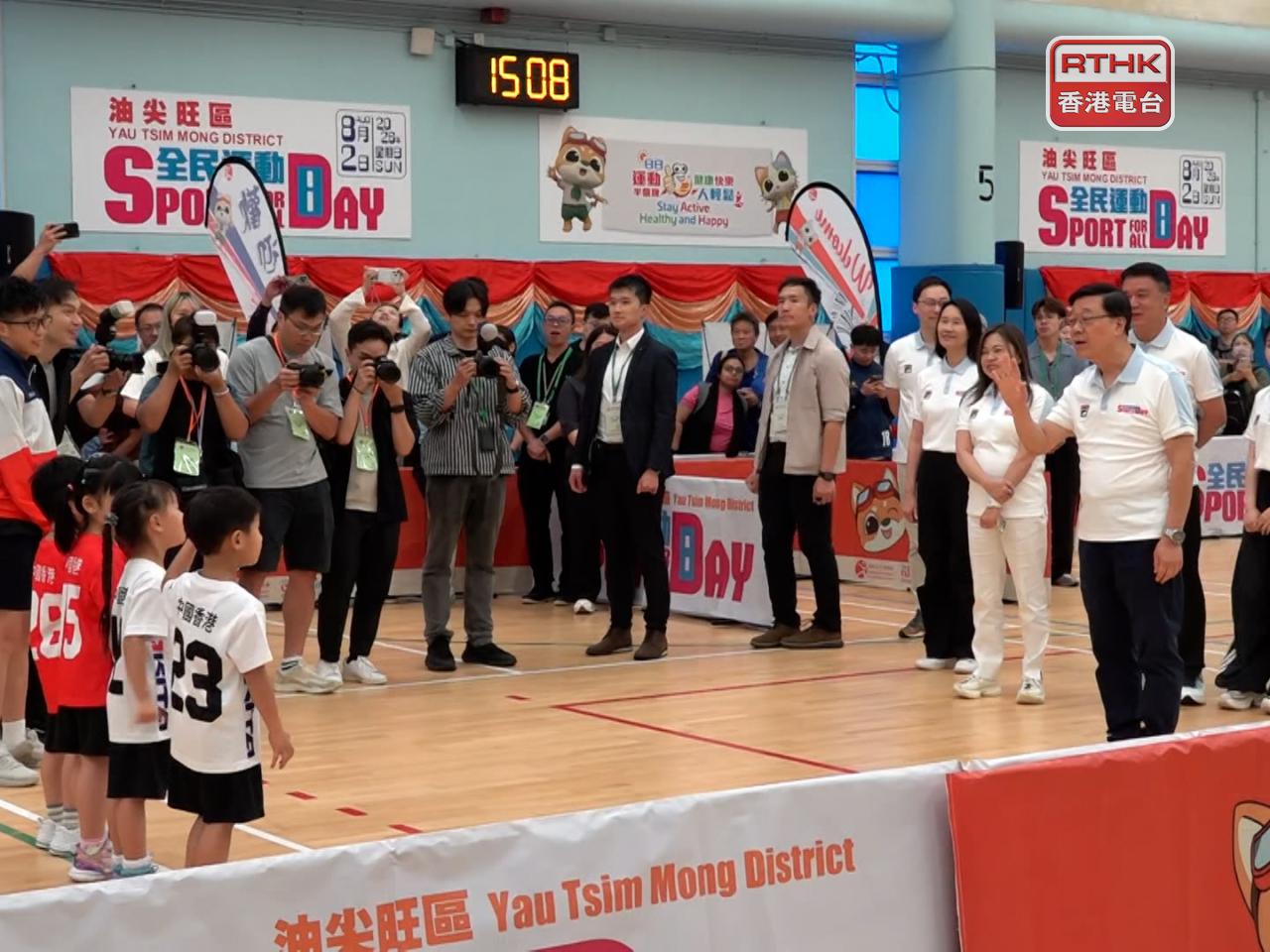 Chief Executive John Lee, right, tries out various sports. Photo: RTHK