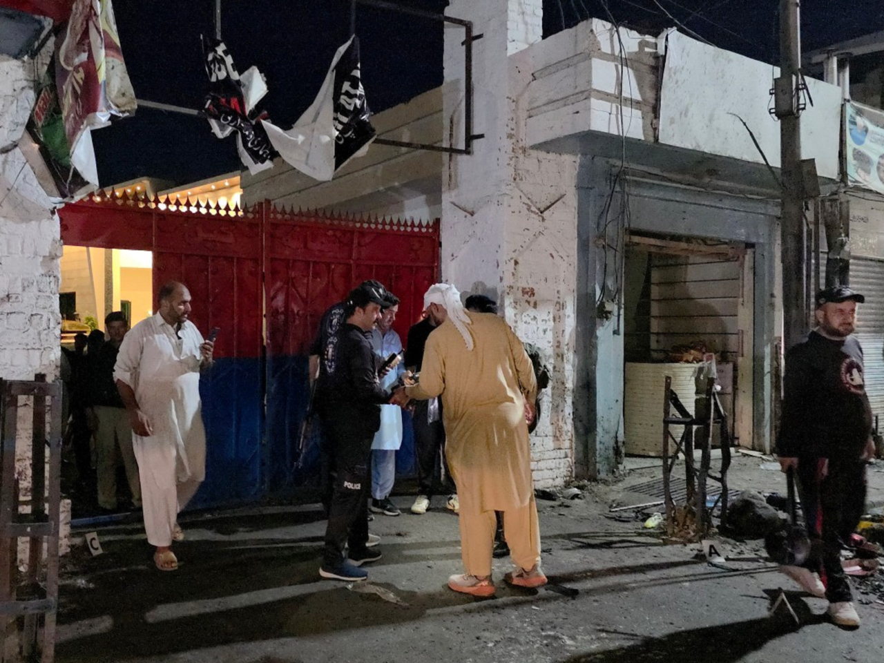 Police officials inspect the site of a suspected suicide bombing in Swat which killed at least 14 people and wounded 18 others. Photo: AFP