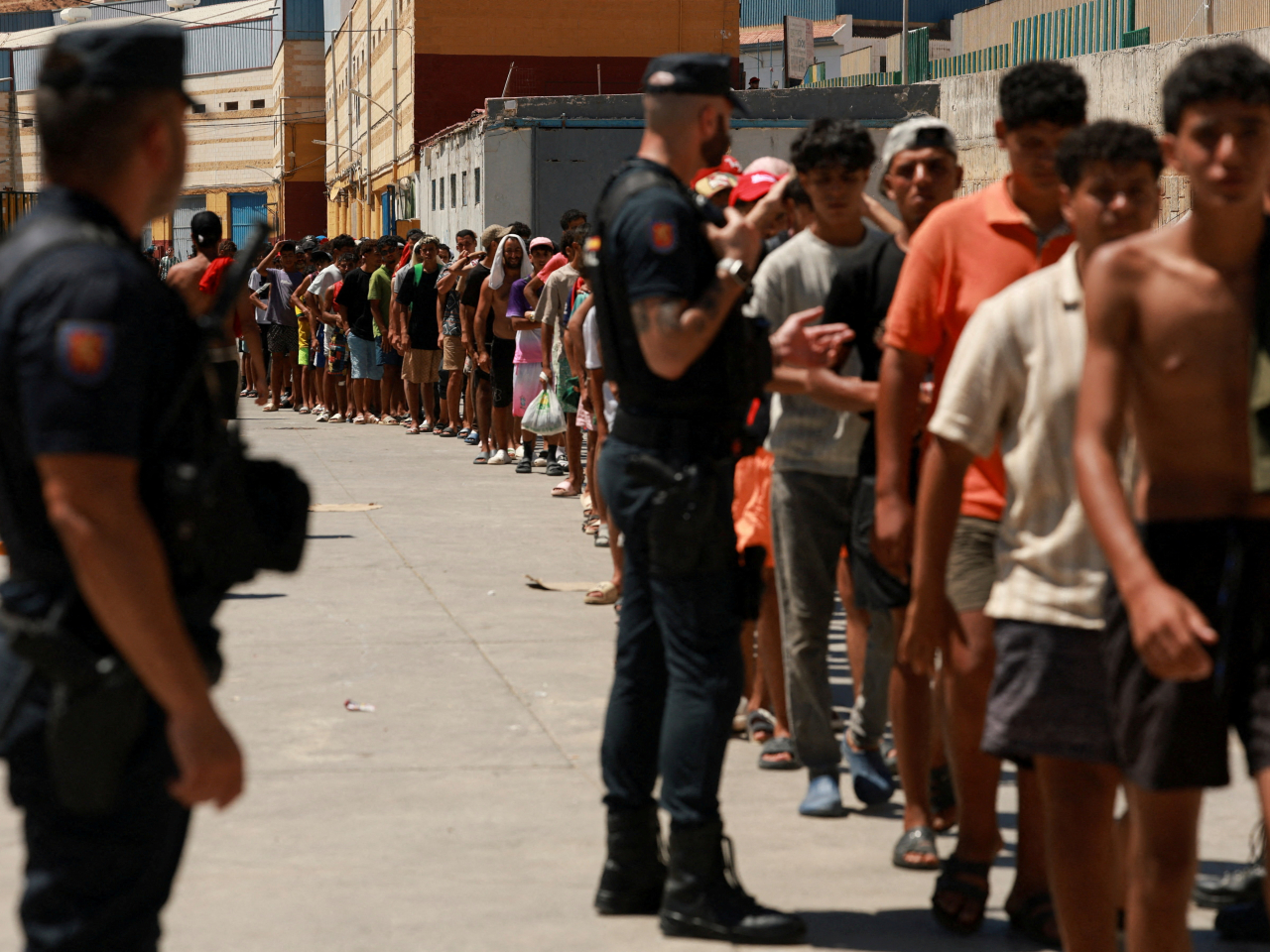 Migrants queue for food staples from local NGO Media Luna Blanca in Ceuta. File photo: Reuters