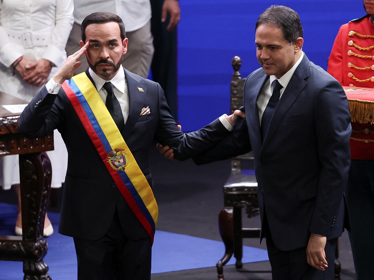 Abelardo De La Espriella salutes next to Senate chief Honorio Henriquez after being sworn in as president in Cali. Photo: Reuters