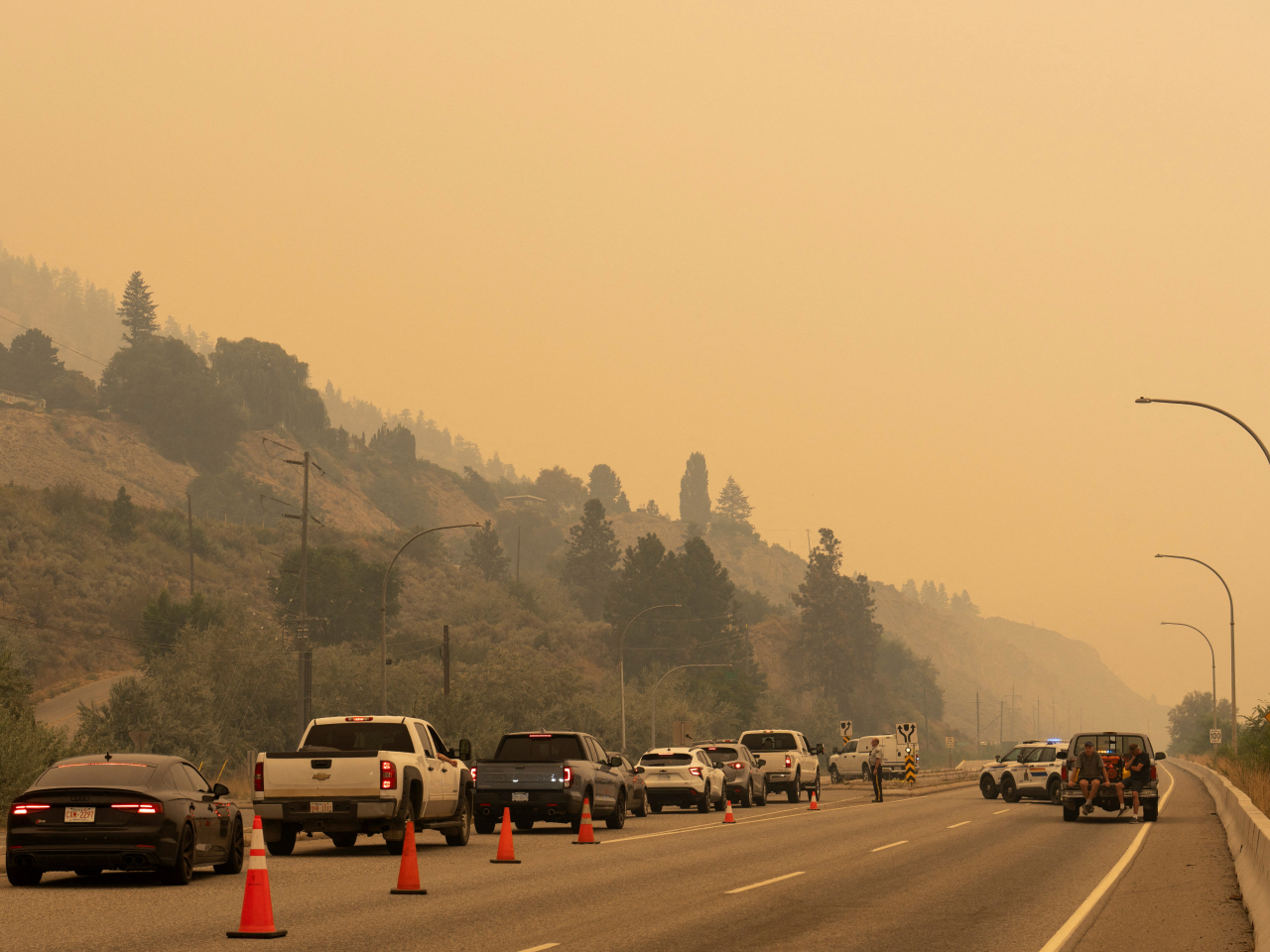 The Royal Canadian Mounted Police block Highway 97 Northbound to direct people away from the Bald Range wildfire in Penticton, British Columbia. Photo: Reuters