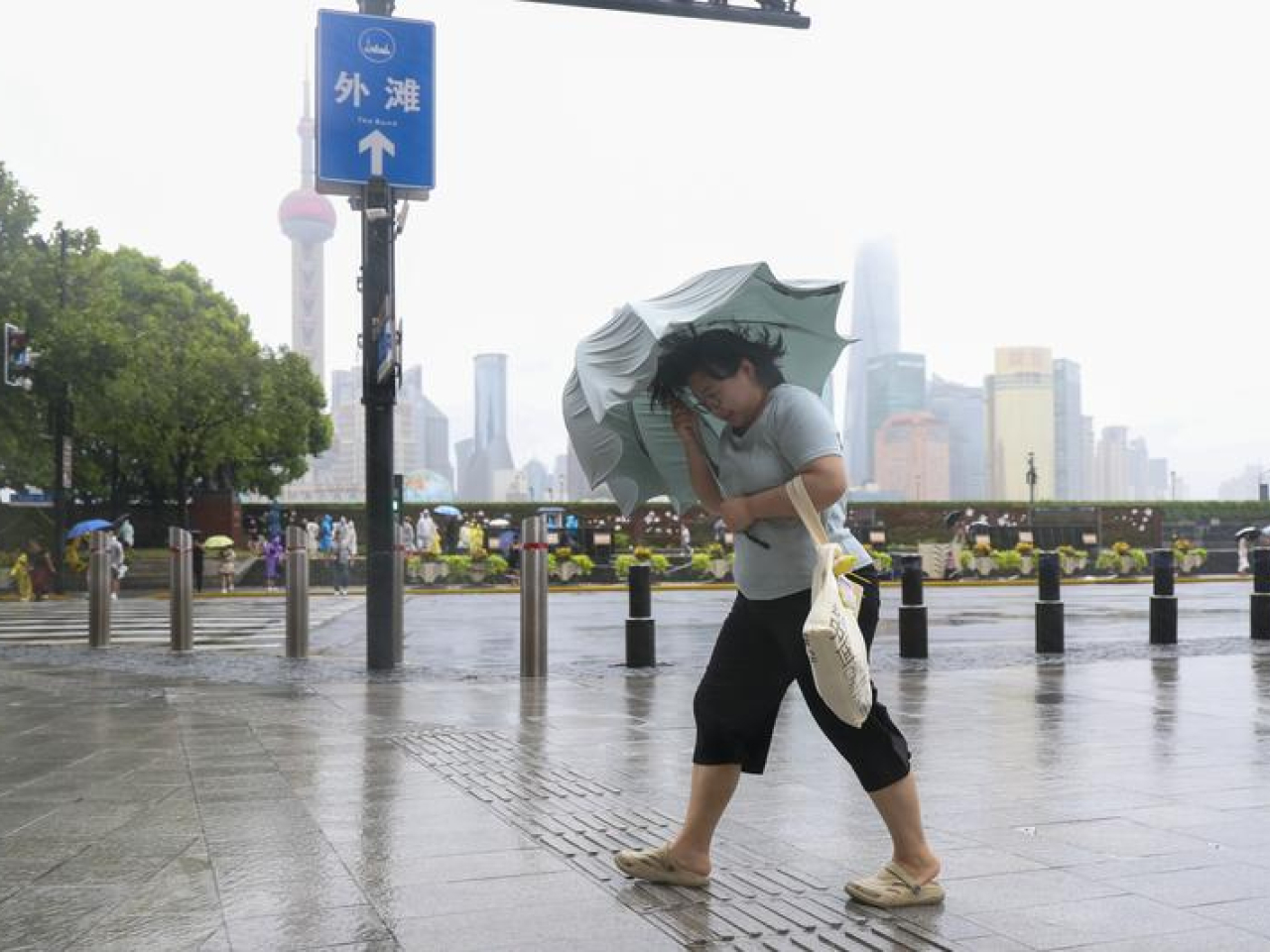在上海黃浦區，民眾冒雨前行。（新華社）