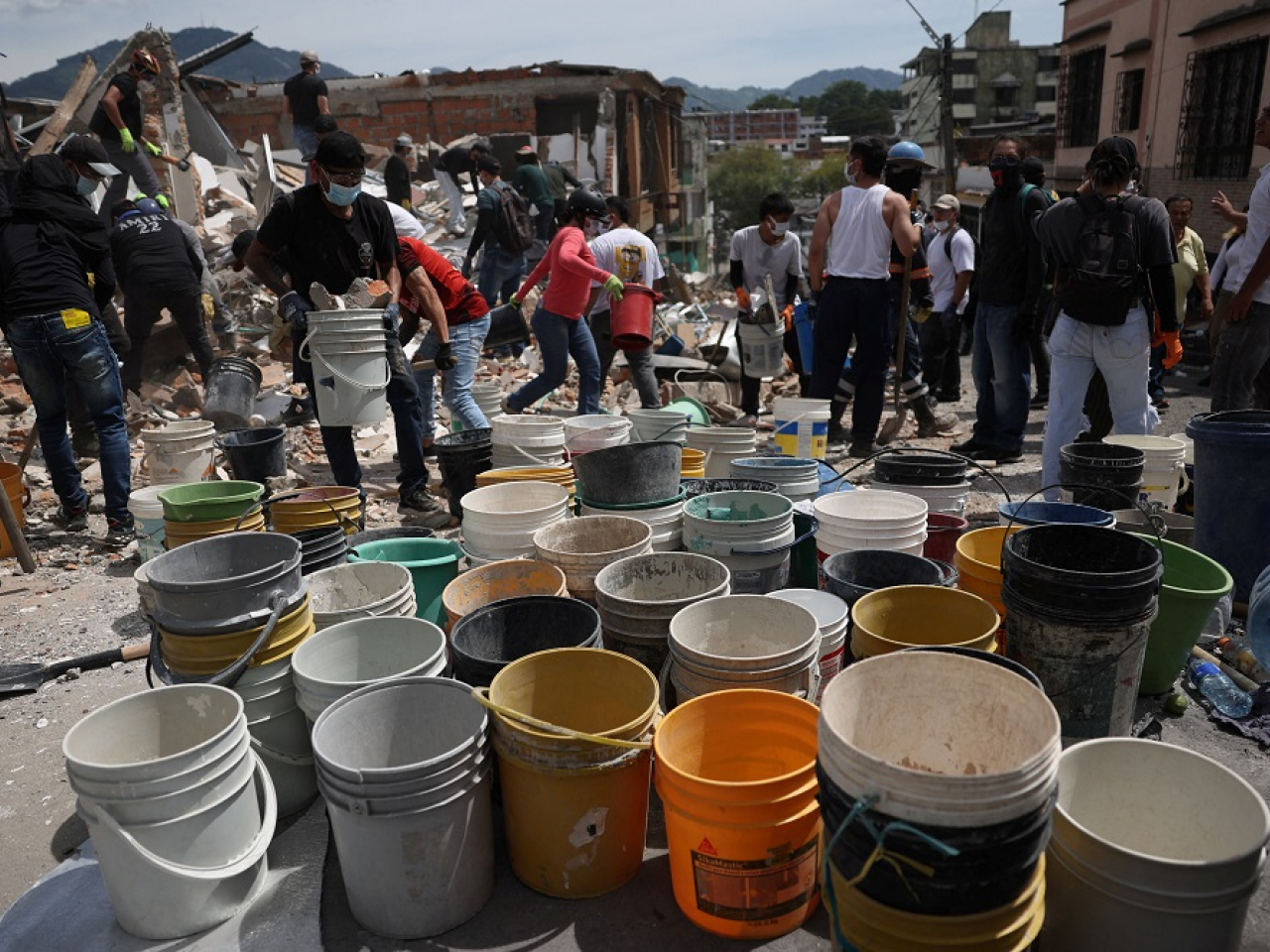 Residents in several cities joined forces with rescue workers to form bucket brigades. Photo: Reuters
