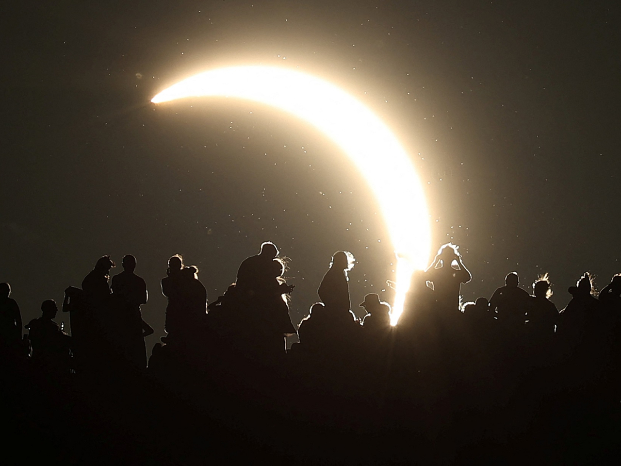 The view of the partial eclipse from Glastonbury Tor in Britain. Photo: Reuters