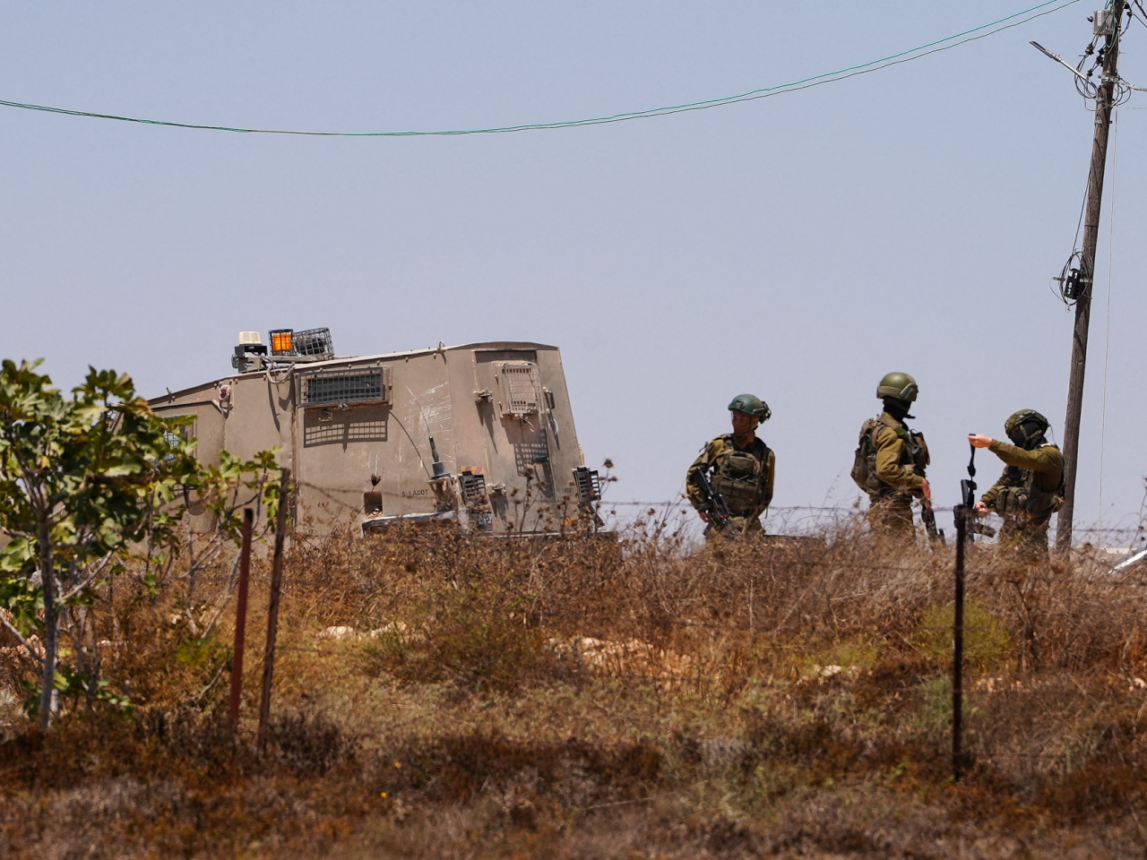 Israeli army soldiers stand near a Palestinian house which was besieged by Israeli settlers in Qusra village in the Israeli-occupied West Bank. Photo: Reuters
