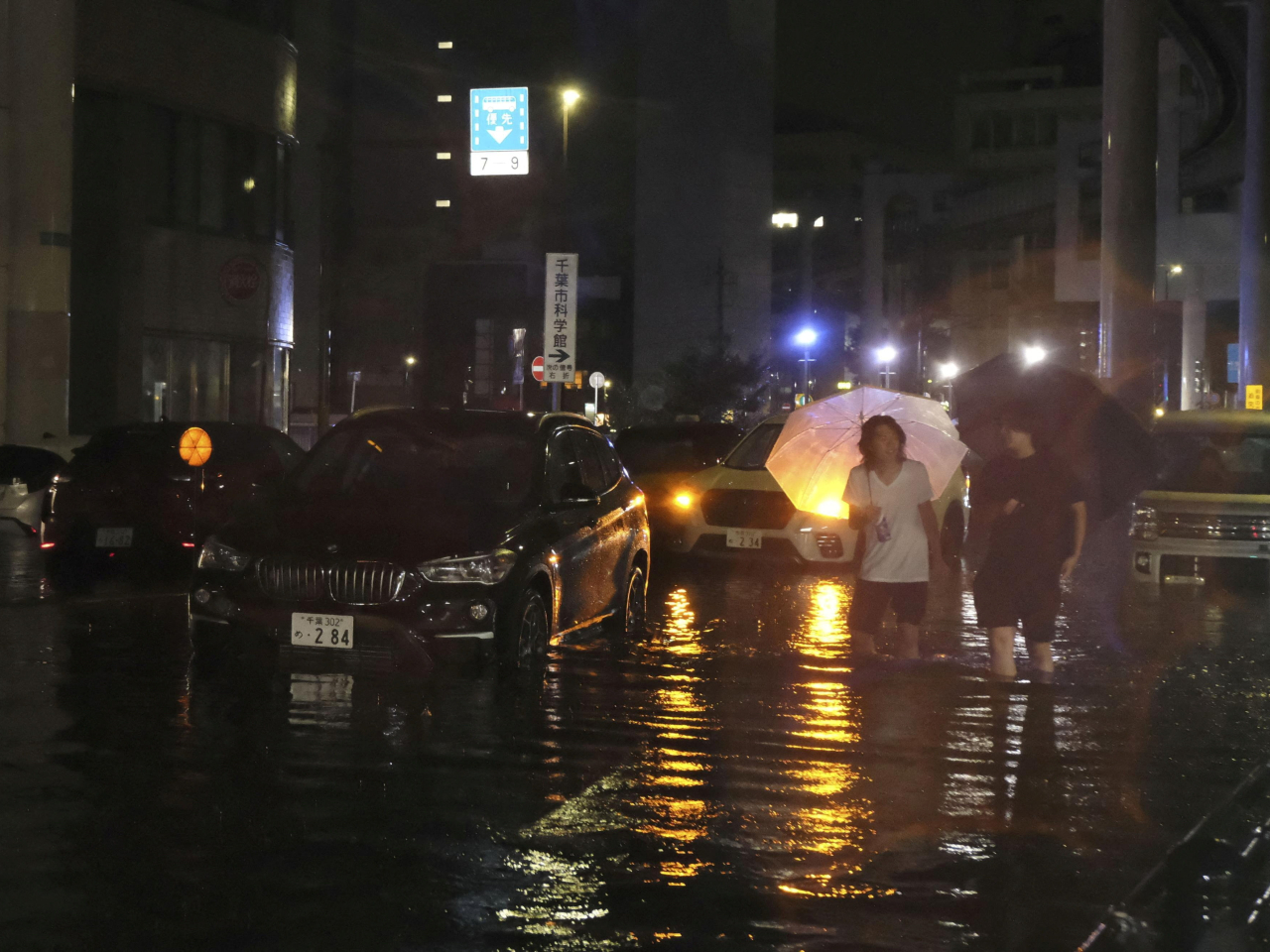 千葉市多處水浸，民眾要涉水而行。（路透社）