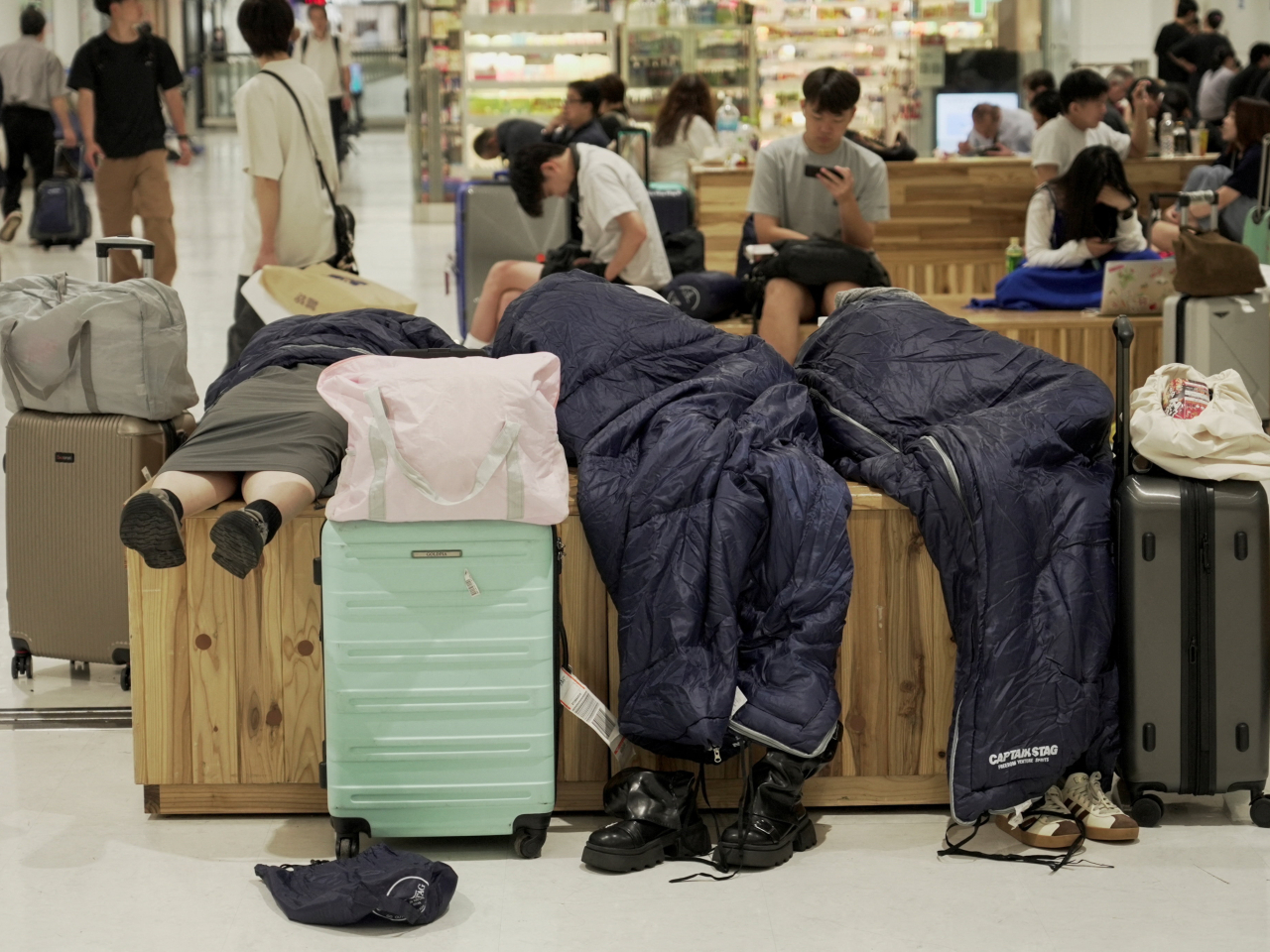 Travellers stuck at Narita airport bed down for the night. Photo: Reuters