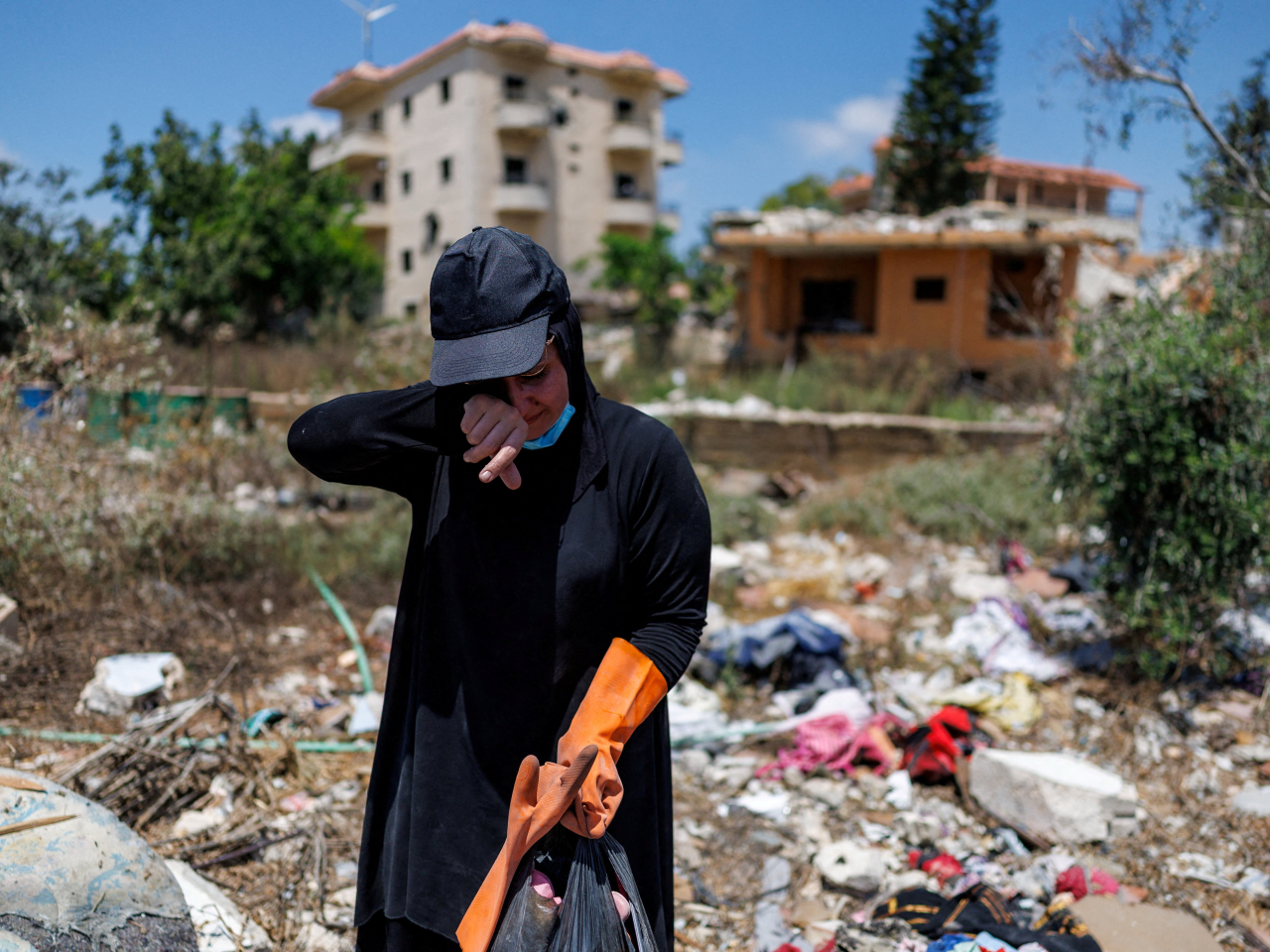 A mother sifts through rubble of her destroyed home by an Israeli strike in Zawtar al-Gharbiyeh, southern Lebanon. Photo: Reuters