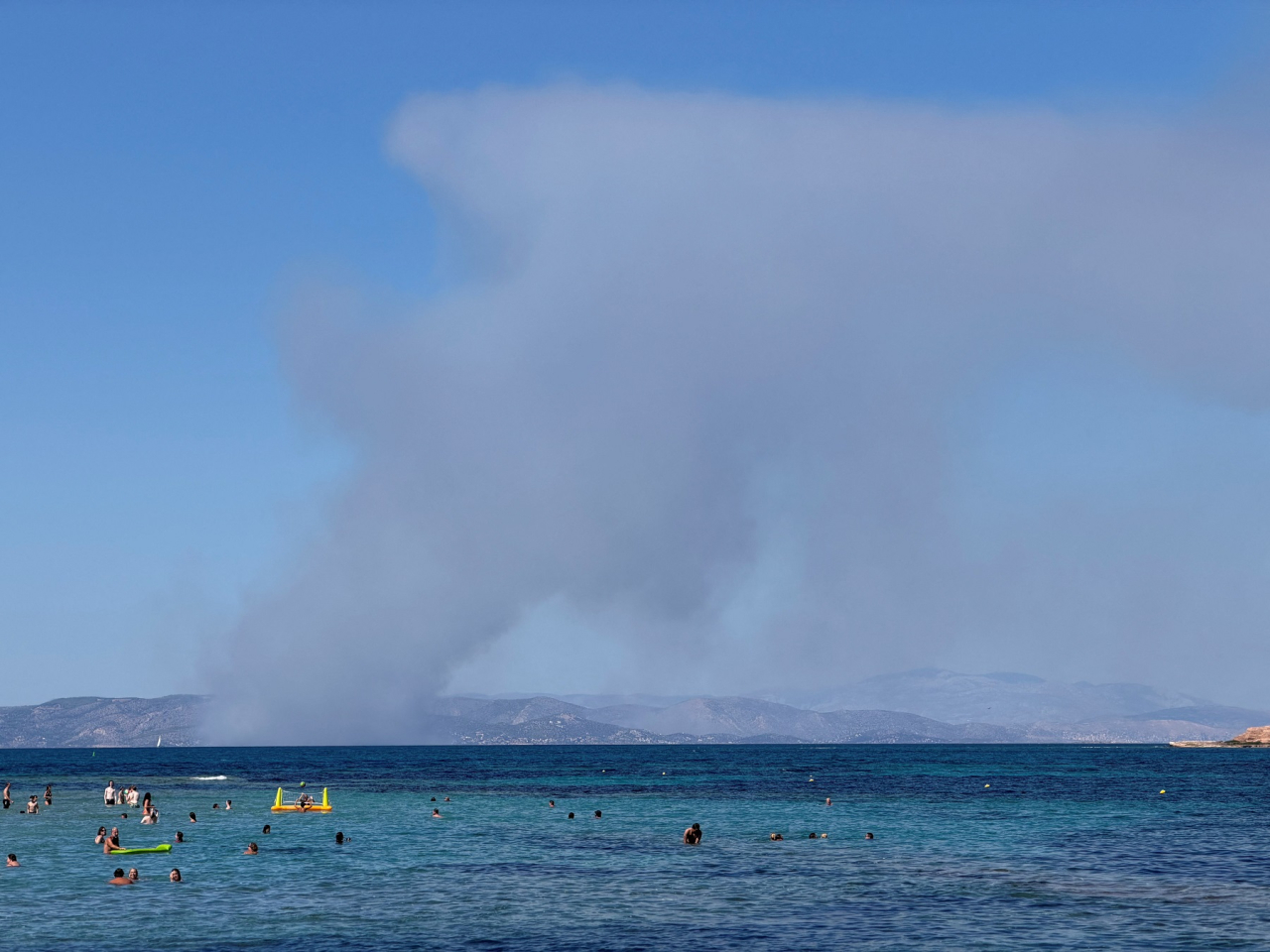 This screengrab from a social media video shows smoke rising in Salamina during a wildfire. Image: Symeon Kranz via Reuters