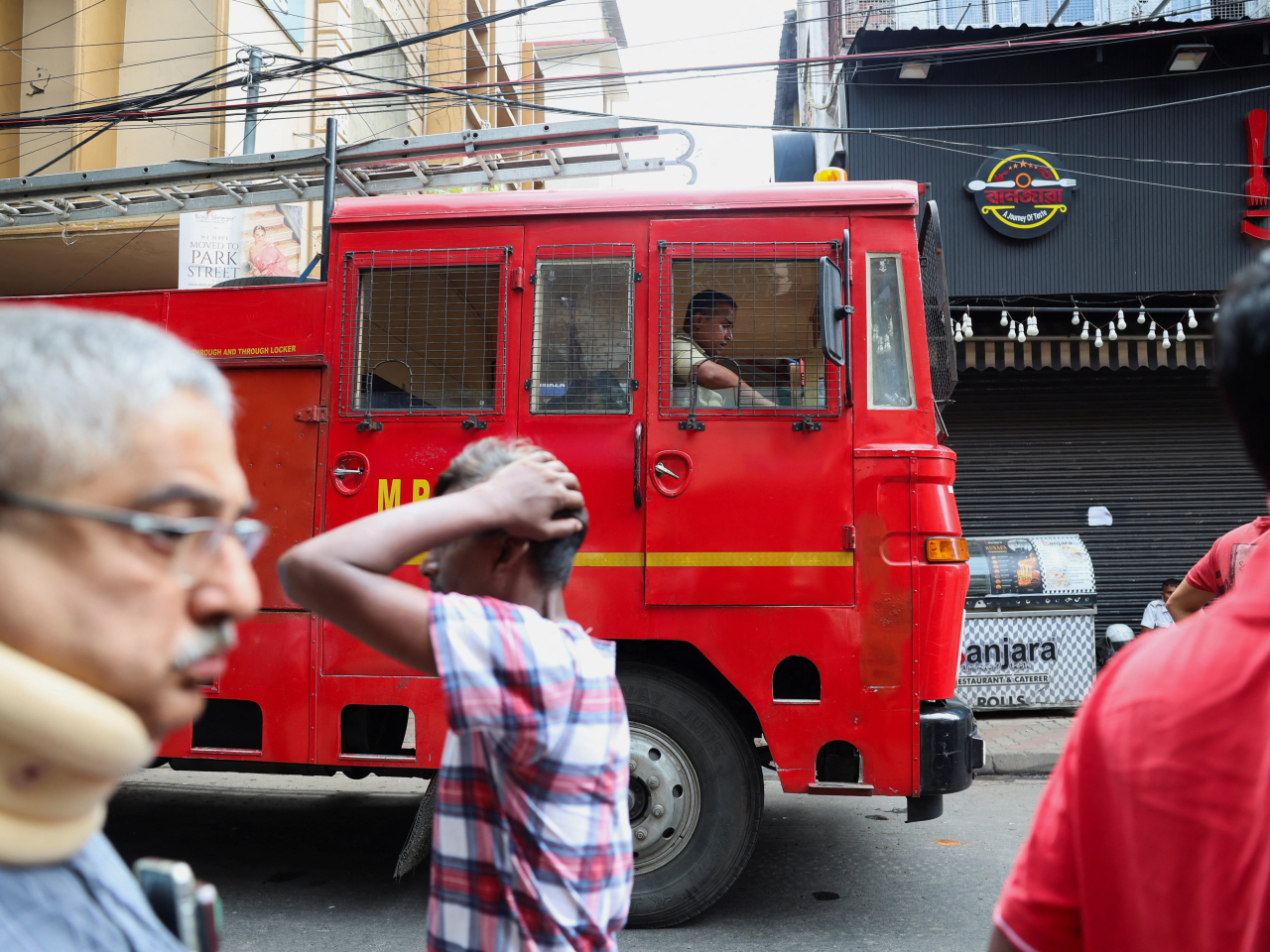 Firefighters arrive on the scene near a hotel where a fire broke out and killed at least nine people in Kolkata. Photo: Reuters
