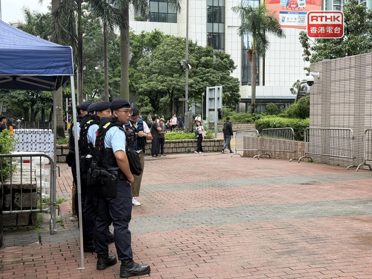 Police officers stood on guard as the verdict was delivered at West Kowloon Court. Photo: RTHK