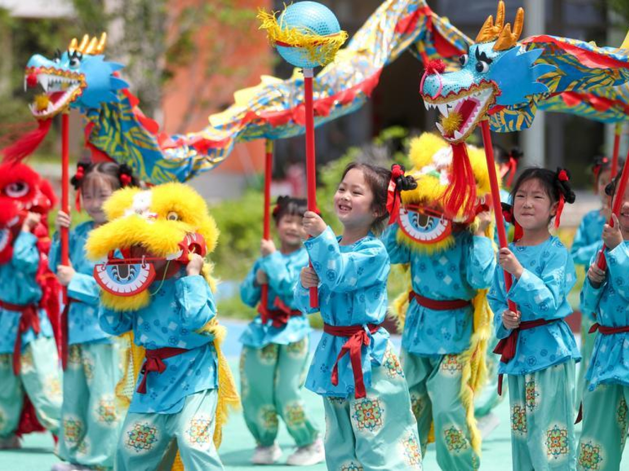 Children perform a dragon and lion dance at a kindergarten in Taizhou, Jiangsu province. China began waiving childcare and education fees for the final year of kindergarten last year. File photo: Zhou Shegen/Xinhua