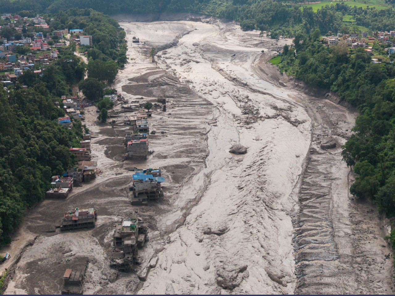 A drone view shows mud covering properties following the flash flood. Photo: Reuters