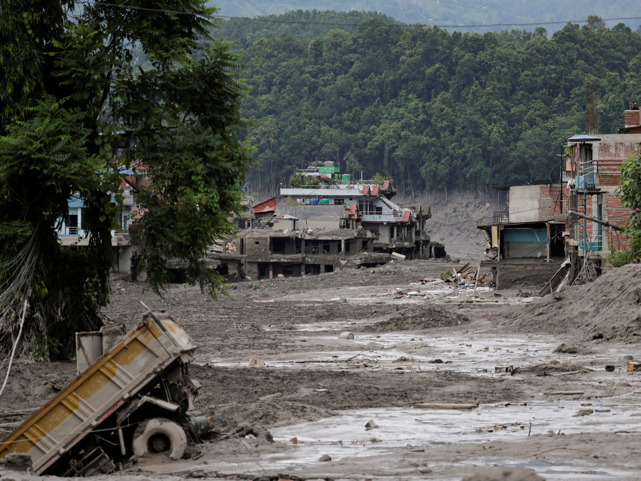 Mud covers houses and a road following a flash flood at Trishuli in Nuwakot district, Nepal. Photo: Reuters