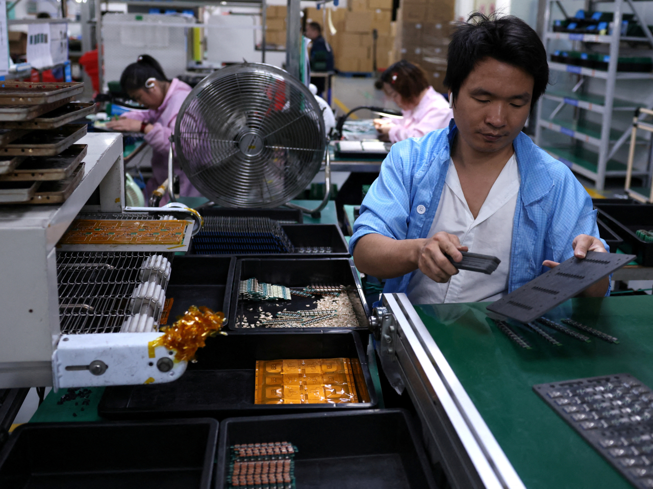 Workers assemble printed circuit boards in Dongguan, Guangdong. File photo: Reuters