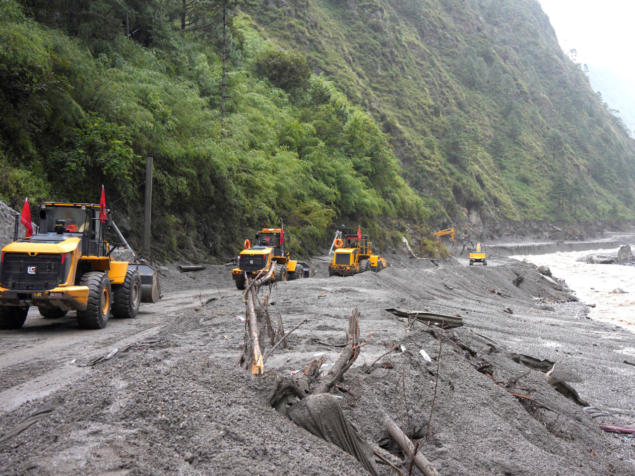 Excavators and loaders repair a road leading to Gyirong Port in Xizang Autonomous Region. Photo: Reuters