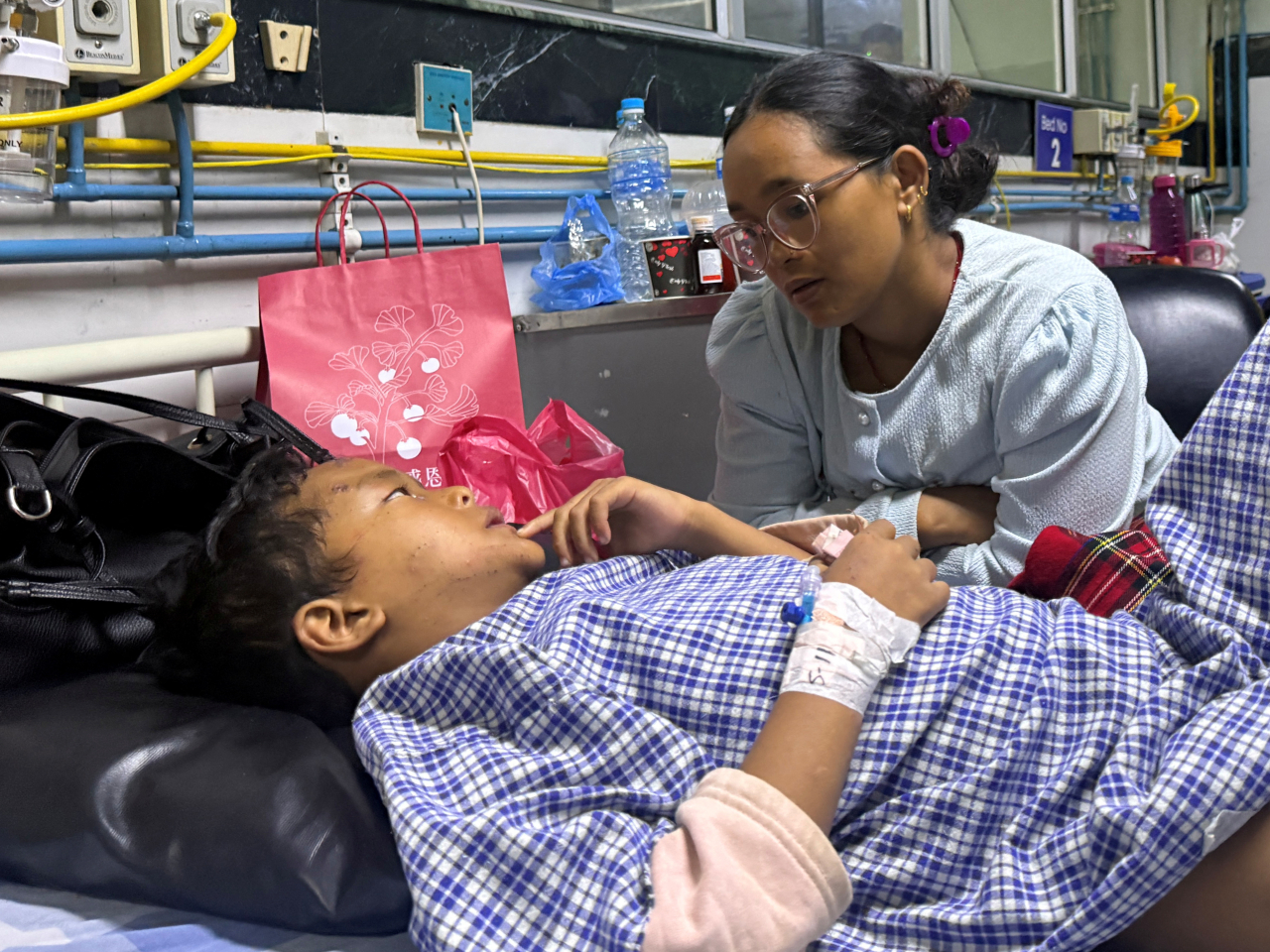 Matti Maya Tamang is reunited with son Zoyal Ghale at a hospital in Kathmandu. Photo: Reuters