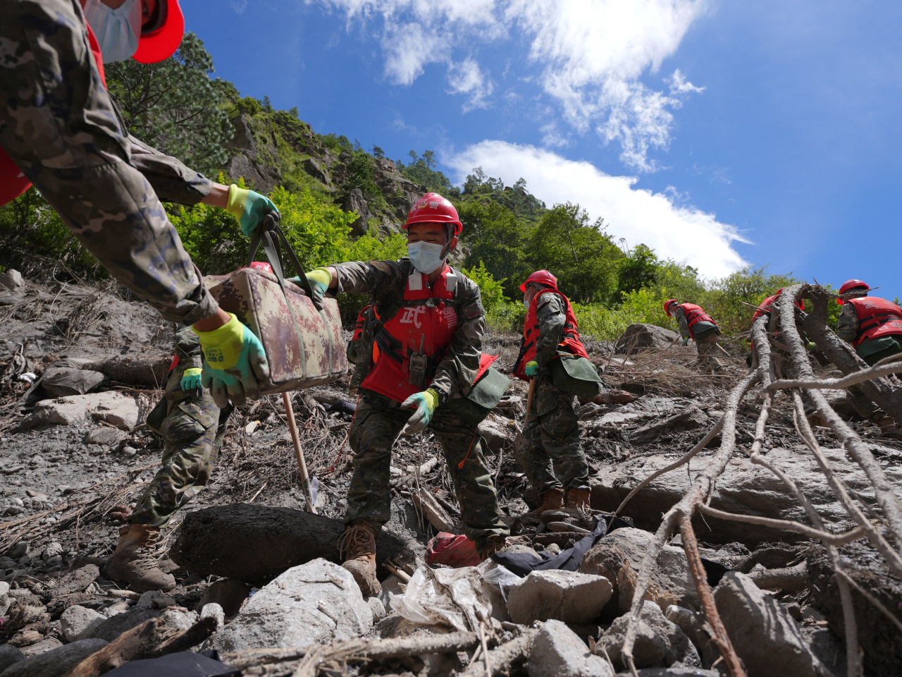 Chinese People's Armed Police officers clear debris near Gyirong Port. Photo: China Daily via Reuters